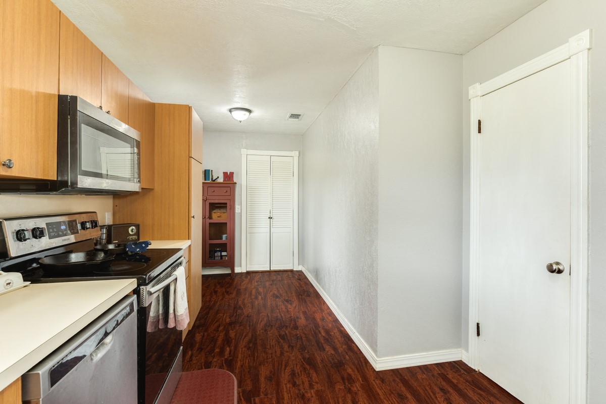 2109 North Tinsley Street Angleton, TX 77515 - Photo 18 of 27 a kitchen with a sink and wooden floor