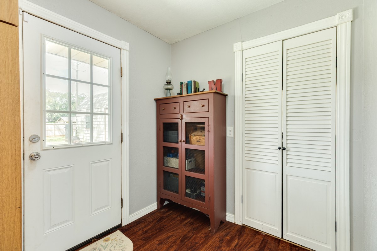 2109 North Tinsley Street Angleton, TX 77515 - Photo 19 of 27 a view of a bedroom with wooden floor closet and windows