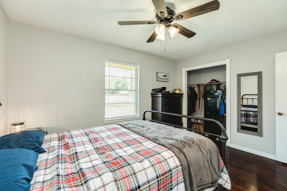 2109 North Tinsley Street Angleton, TX 77515 - Photo 23 of 27 a bedroom with a bed and a chandelier