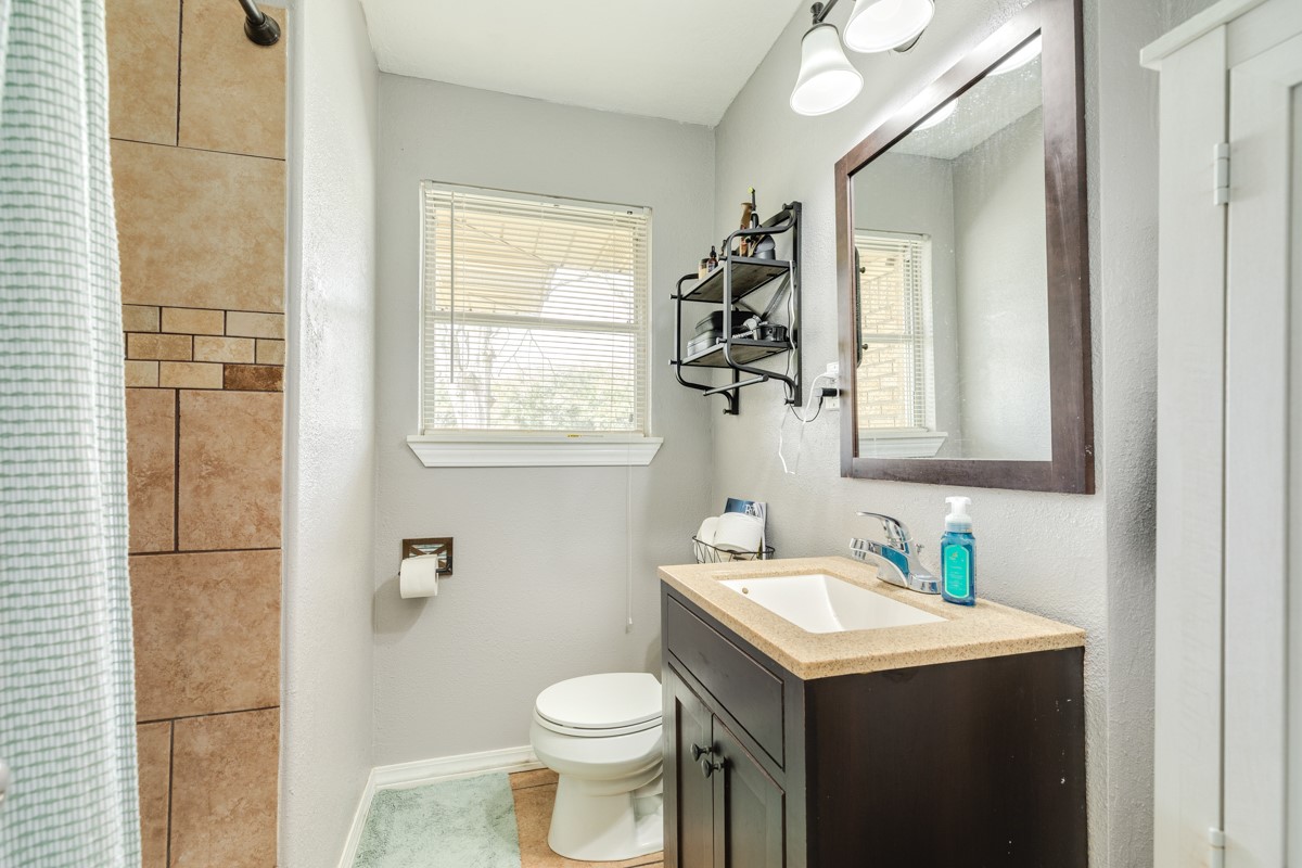 2109 North Tinsley Street Angleton, TX 77515 - Photo 26 of 27 a bathroom with a sink toilet and mirror