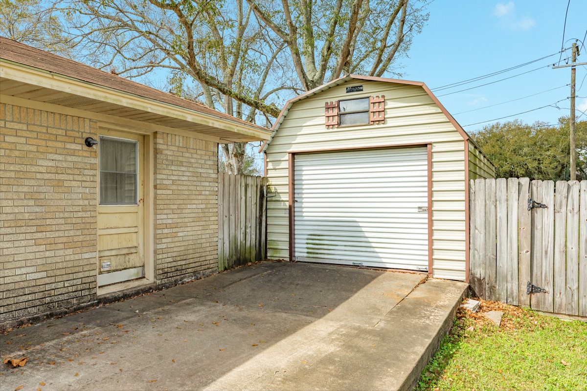 2109 North Tinsley Street Angleton, TX 77515 - Photo 5 of 27 a view of a white house with a large windows