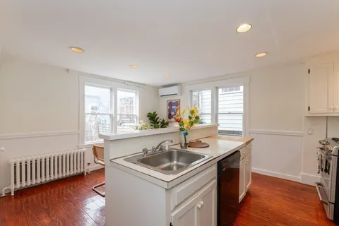 a kitchen with a sink appliances and cabinets