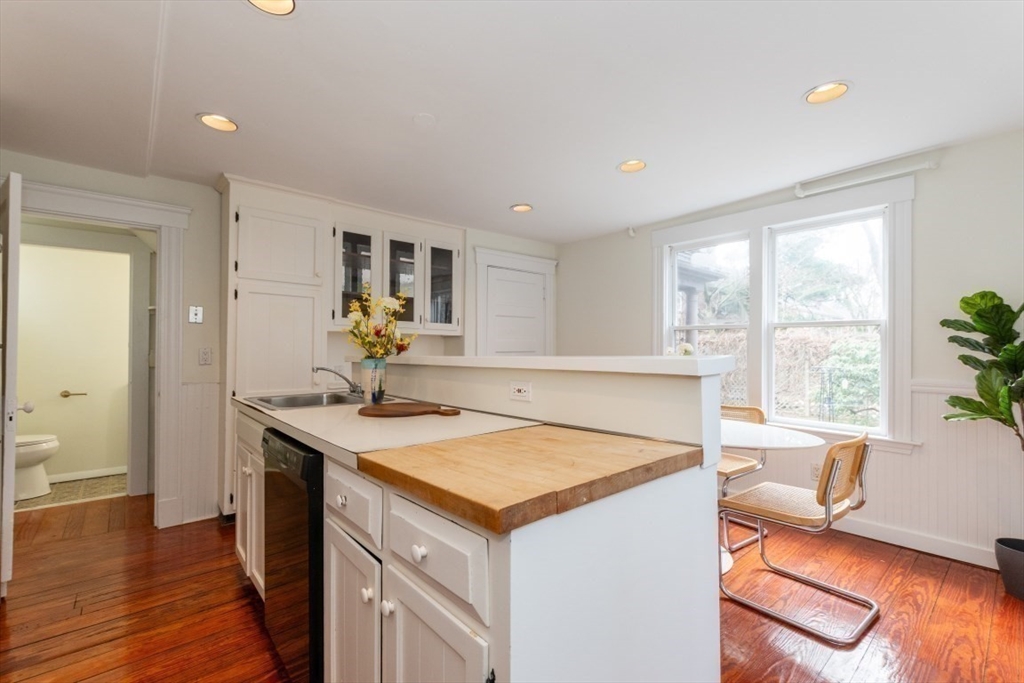 20 Maynard Place Cambridge, MA 02138 - Photo 15 of 42 a view of kitchen island a sink wooden floor and a living room