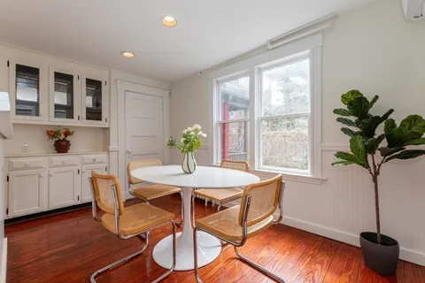 a dining room with furniture and window