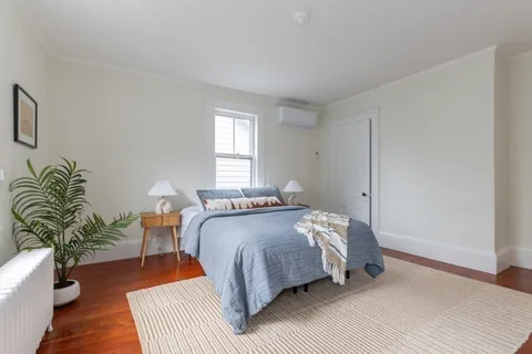 a bedroom with a bed table and a couch