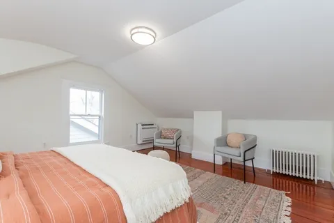 a bedroom with bed and a window