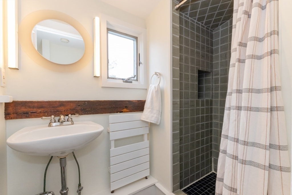 20 Maynard Place Cambridge, MA 02138 - Photo 28 of 42 a bathroom with a sink a mirror and a shower