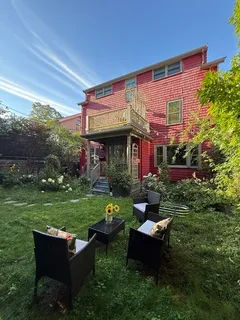 a backyard of a house with outdoor seating