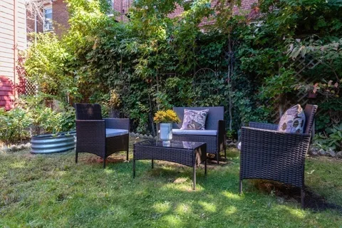a wooden bench sitting in the middle of a garden