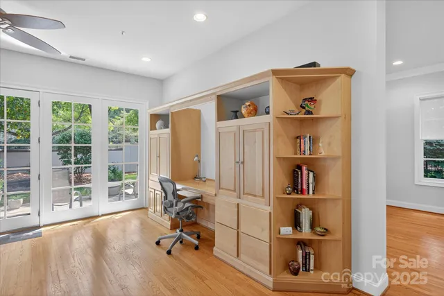 a view of a livingroom with workspace and a book shelf