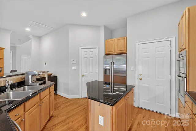 a kitchen with granite countertop a sink and refrigerator