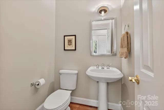 a bathroom with a sink mirror and toilet