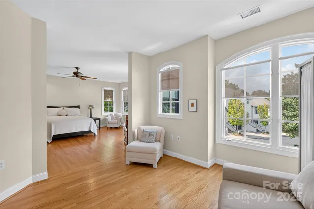 a bedroom with furniture and a large window