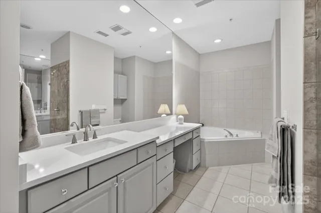 a bathroom with a bathtub shower sink double and mirror