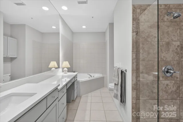 a spacious bathroom with a double vanity sink mirror double and shower