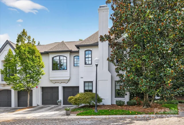 a house that has a tree in front of it