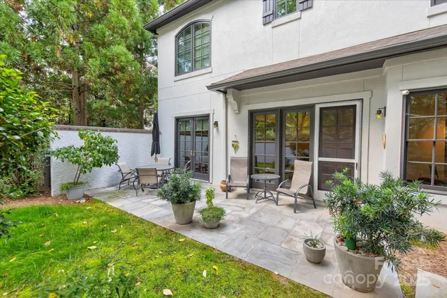 a view of a chair and table in backyard of the house