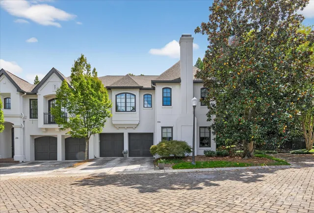 a front view of a house with a garden and plants