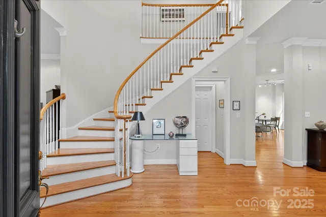 a view of entryway and hall with wooden floor