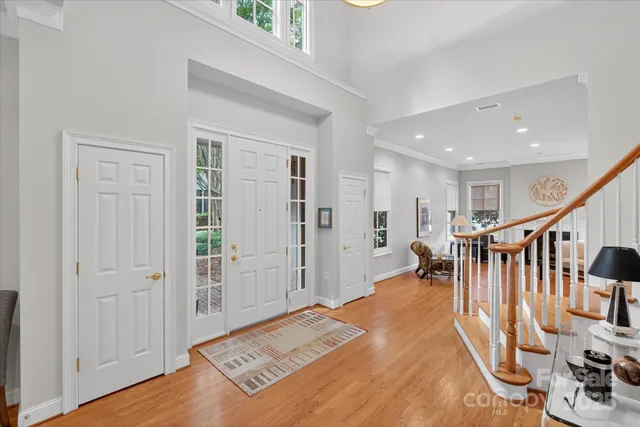 a view of a hallway with wooden floor and windows