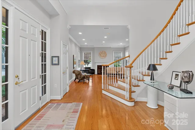 a view of entryway and hall with wooden floor