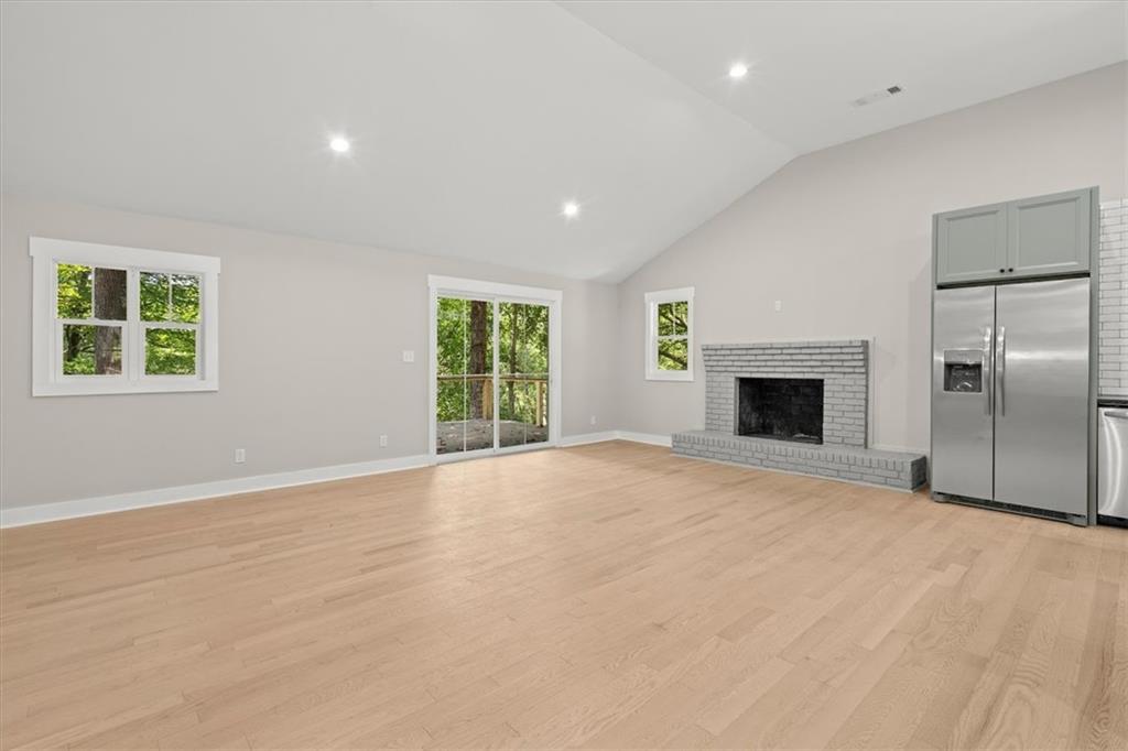 2237 Clem Lowell Road Carrollton, GA 30116 - Photo 12 of 60 an empty room with windows and fireplace