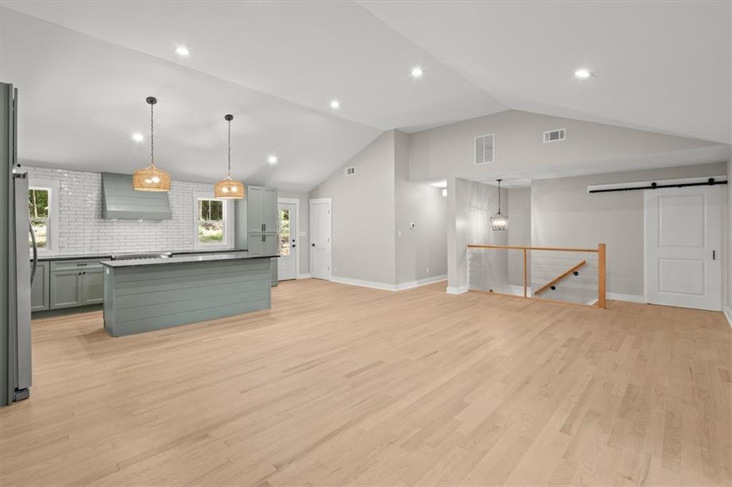 2237 Clem Lowell Road Carrollton, GA 30116 - Photo 13 of 60 a large kitchen with a large counter top a sink stainless steel appliances and cabinets