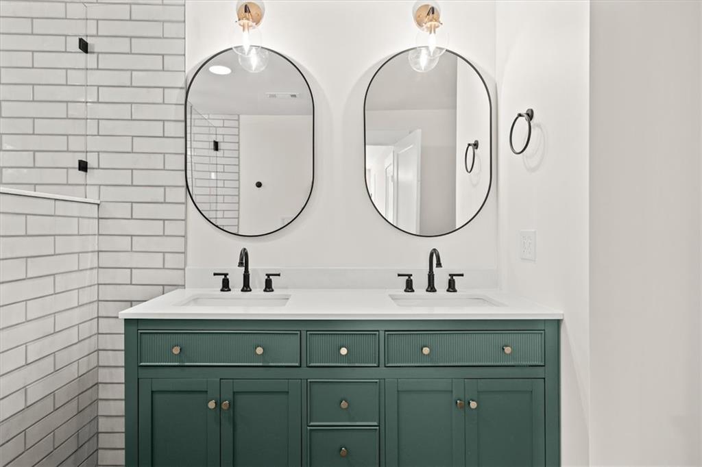 2237 Clem Lowell Road Carrollton, GA 30116 - Photo 16 of 60 a bathroom with a double vanity sink and a mirror