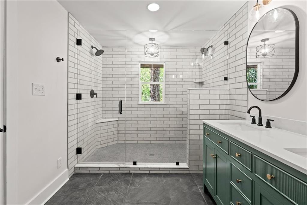 2237 Clem Lowell Road Carrollton, GA 30116 - Photo 17 of 60 a bathroom with a sink a shower and a mirror