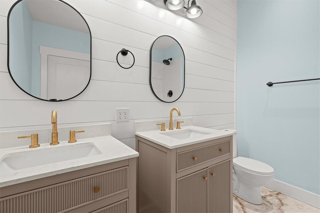 2237 Clem Lowell Road Carrollton, GA 30116 - Photo 30 of 60 a bathroom with a toilet sink and mirror