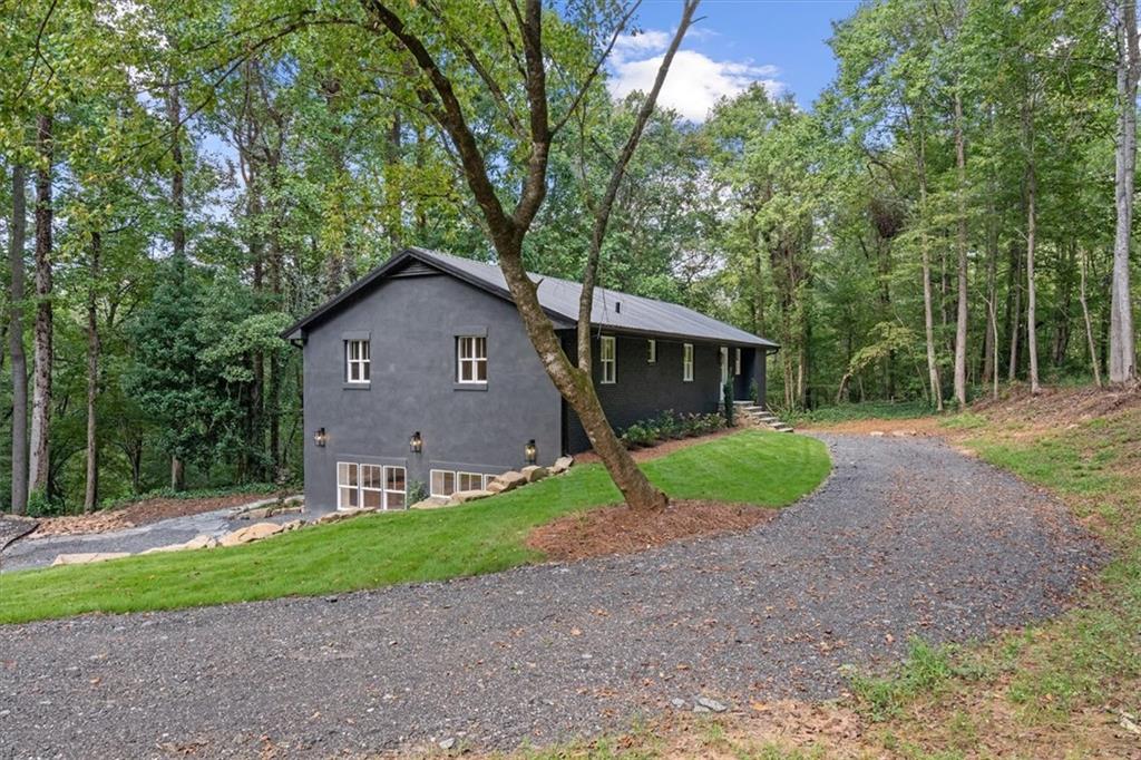 2237 Clem Lowell Road Carrollton, GA 30116 - Photo 3 of 60 a view of a house with a yard and large trees