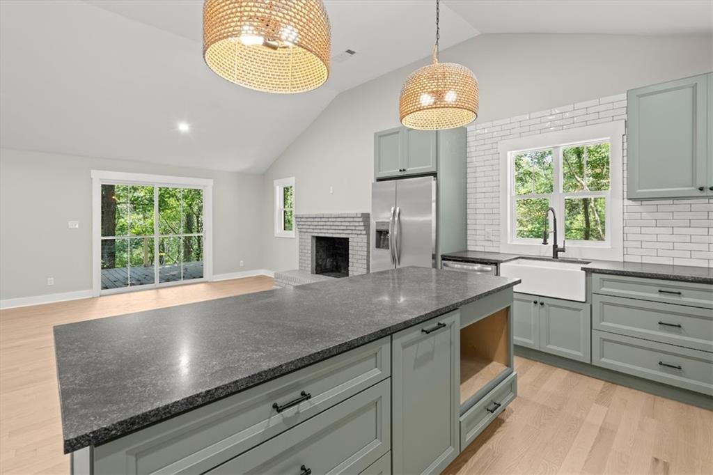 2237 Clem Lowell Road Carrollton, GA 30116 - Photo 7 of 60 a kitchen with kitchen island granite countertop a stove and a large window