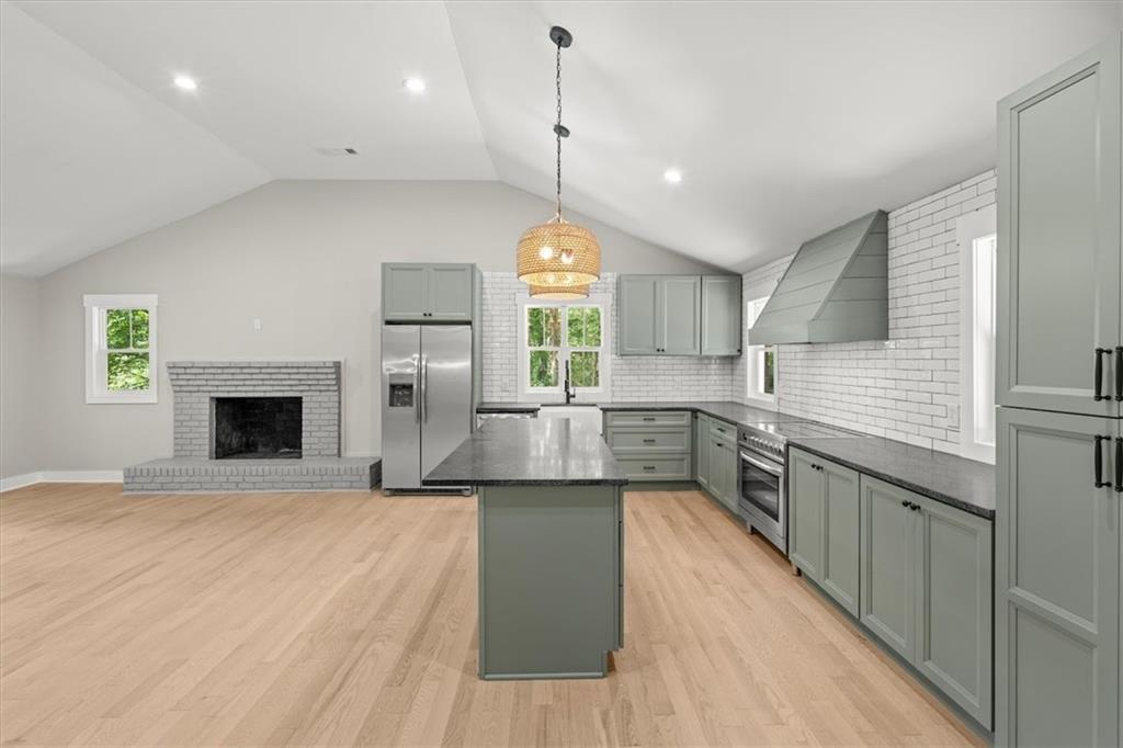 2237 Clem Lowell Road Carrollton, GA 30116 - Photo 10 of 60 a kitchen with stainless steel appliances granite countertop a stove a sink dishwasher and a wooden cabinets