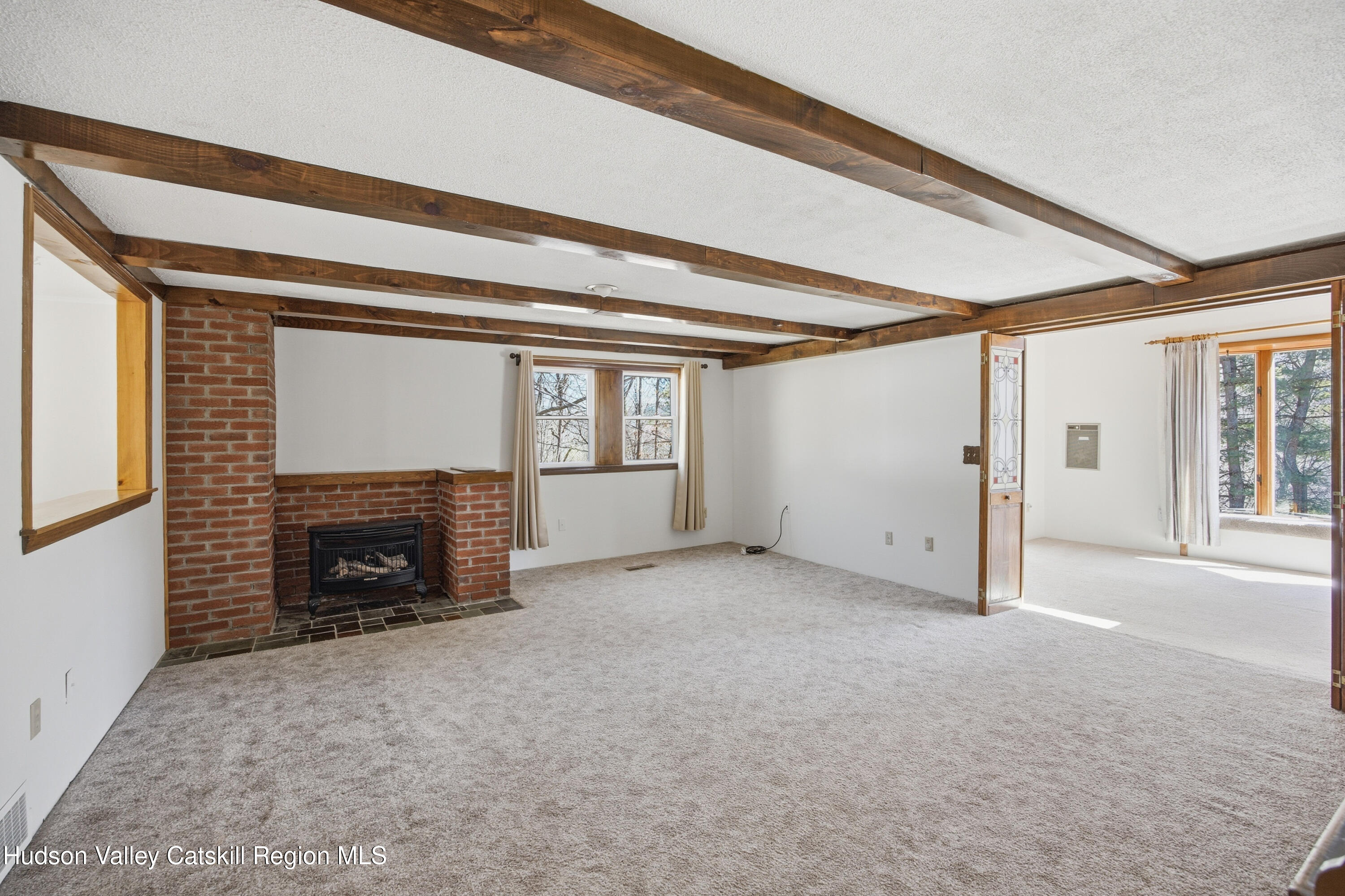 524 Angel Hill Road Chatham, NY 12037 - Photo 11 of 33 a view of an empty room with a fireplace and a window