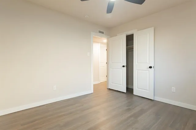 a view of a hallway with wooden floor