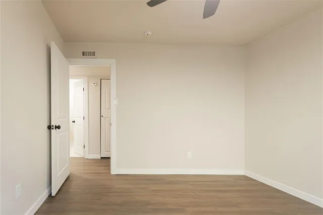 an empty room with wooden floor