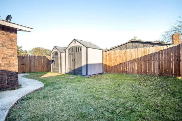 a view of backyard with garage