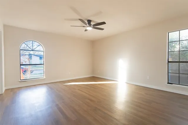 a kitchen with wooden floors and refrigerator