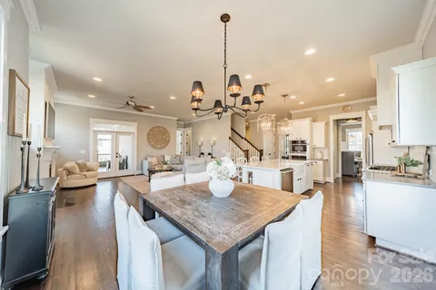 a kitchen island with granite countertop lots of counter top space and living room view