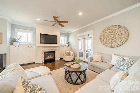 a living room with furniture a fireplace and a flat screen tv