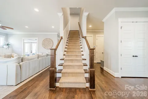 a view of entryway and hall with wooden floor