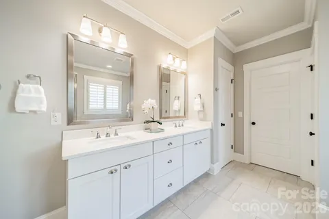 a spacious bathroom with a granite countertop sink a mirror a bathtub and shower