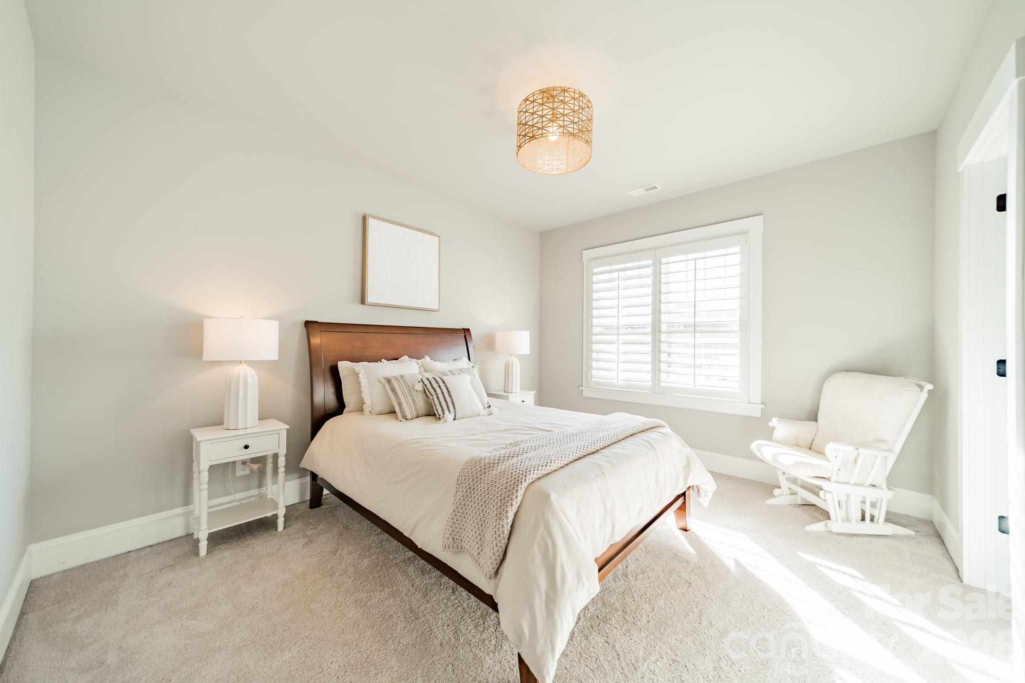 2289 Tatton Hall Road Fort Mill, SC 29715 - Photo 30 of 48 a bedroom with a bed and a chair