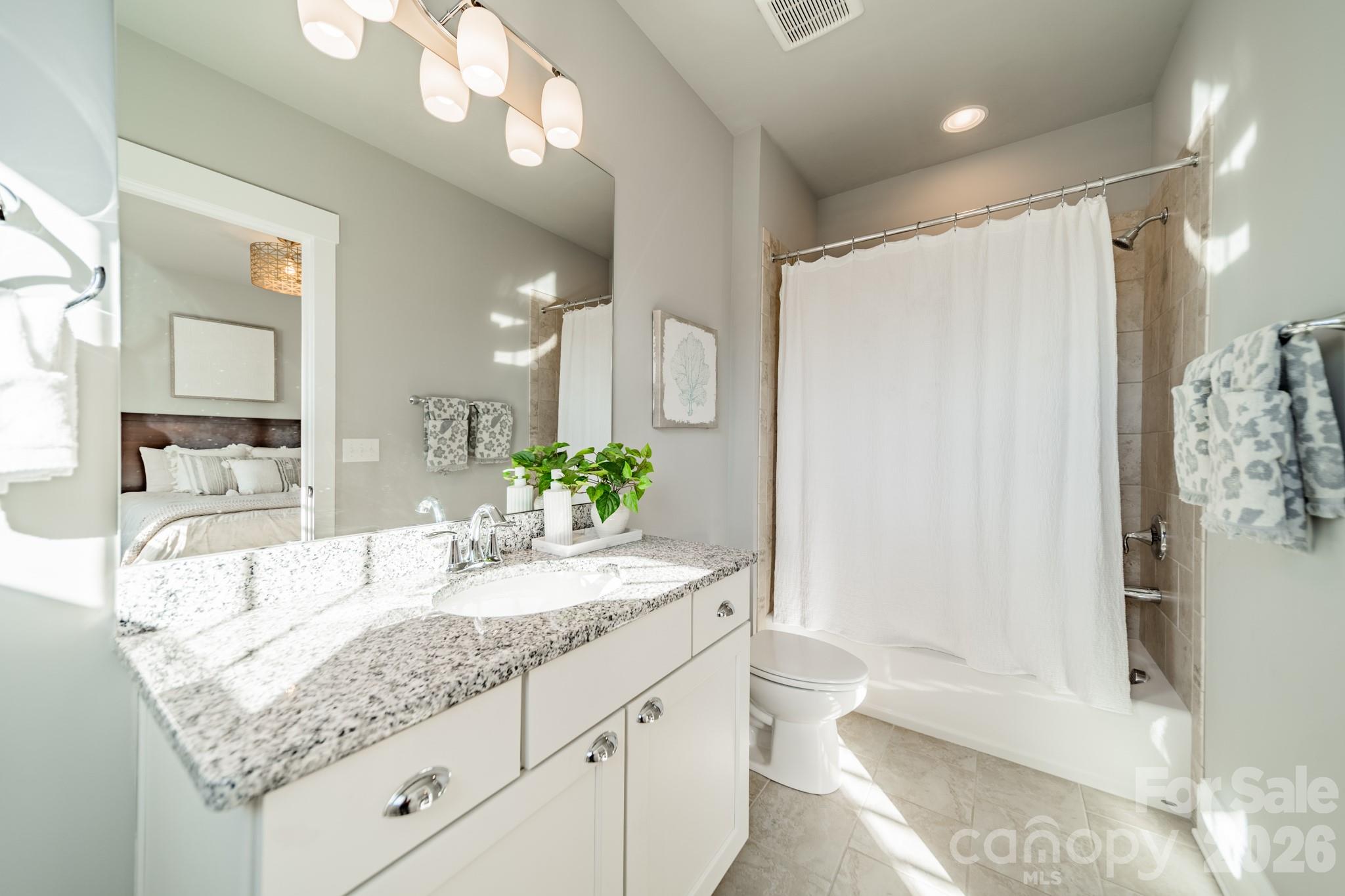 2289 Tatton Hall Road Fort Mill, SC 29715 - Photo 31 of 48 a bathroom with a granite countertop sink and a mirror