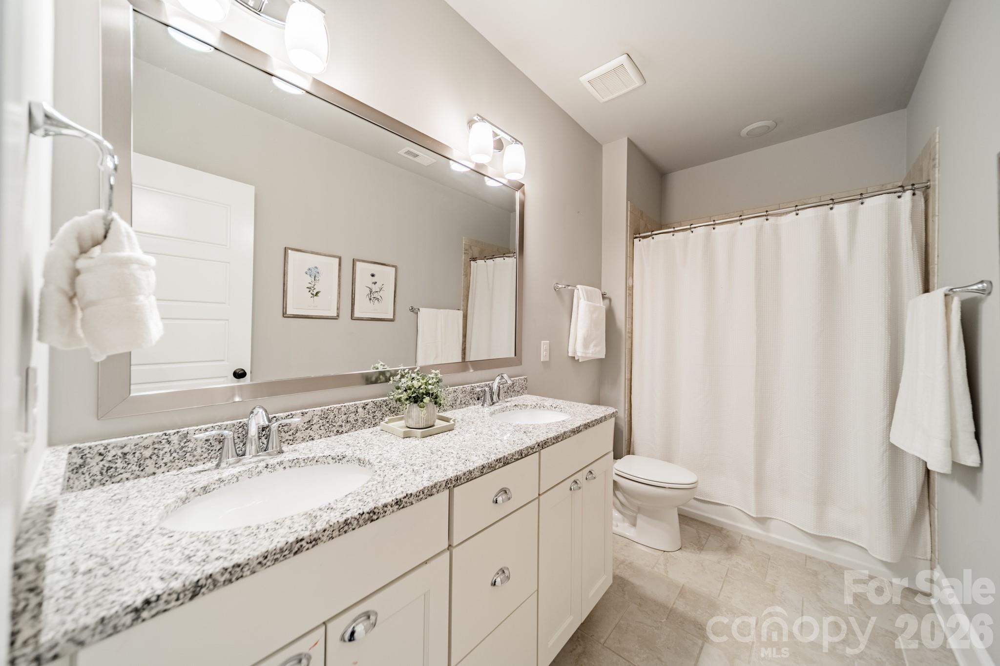 2289 Tatton Hall Road Fort Mill, SC 29715 - Photo 34 of 48 a bathroom with a granite countertop sink toilet and shower
