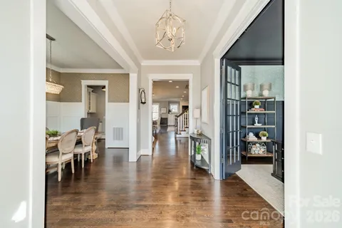 a view of a dining room with furniture wooden floor and a chandelier