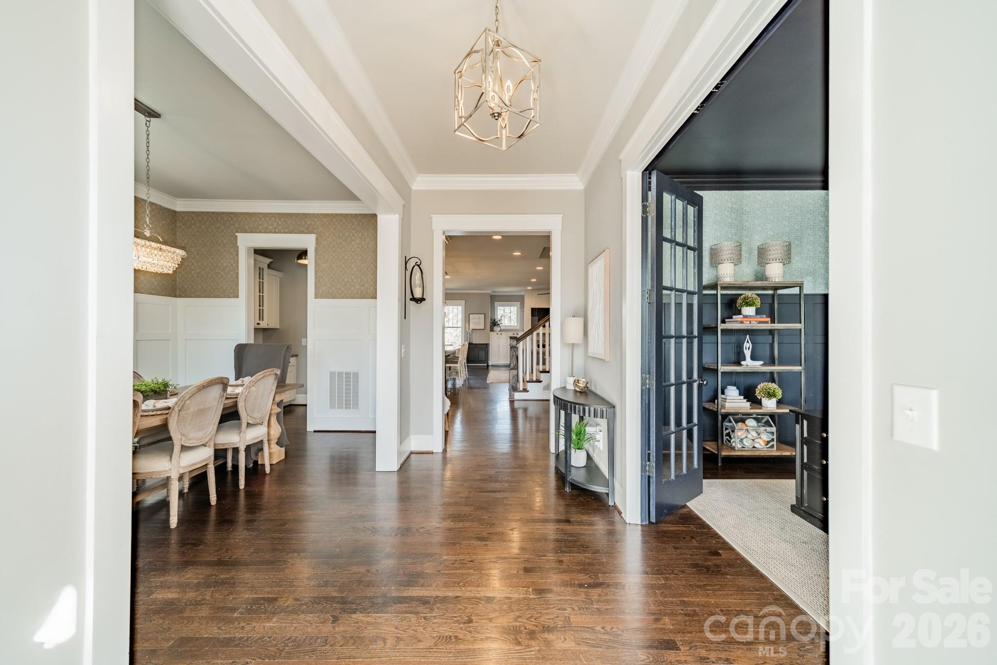 2289 Tatton Hall Road Fort Mill, SC 29715 - Photo 4 of 48 a view of a dining room with furniture wooden floor and a chandelier
