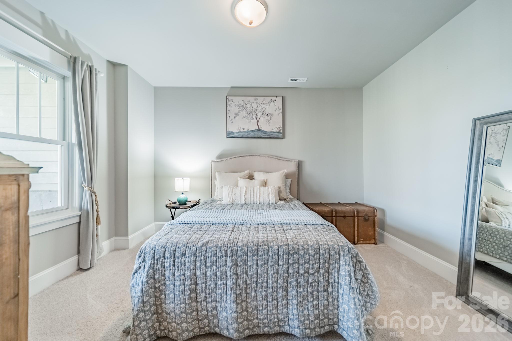 2289 Tatton Hall Road Fort Mill, SC 29715 - Photo 41 of 48 a bedroom with a bed and a lamp with window