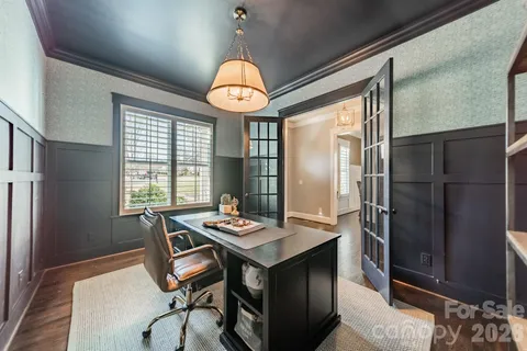 a kitchen with a refrigerator a table and chairs in it