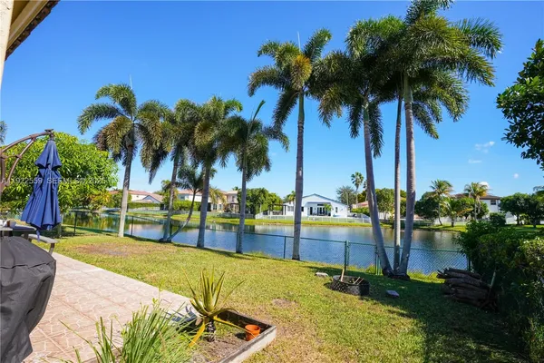 a view of swimming pool with a garden and patio